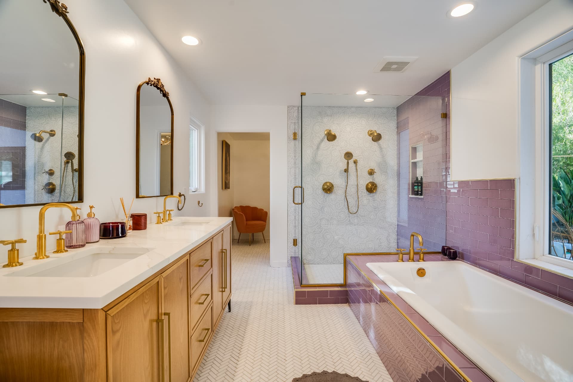 Primary bathroom remodel with white oak double vanity, quartz counters, brass fixtures, and lilac tile around a soaking tub in Los Angeles